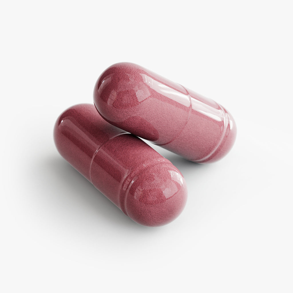 Two pink capsules on a white background