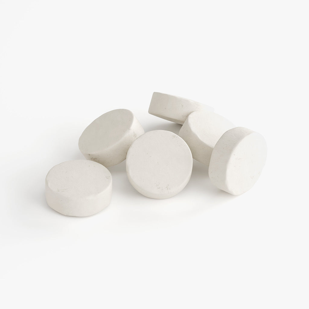 White round tablets on a white background