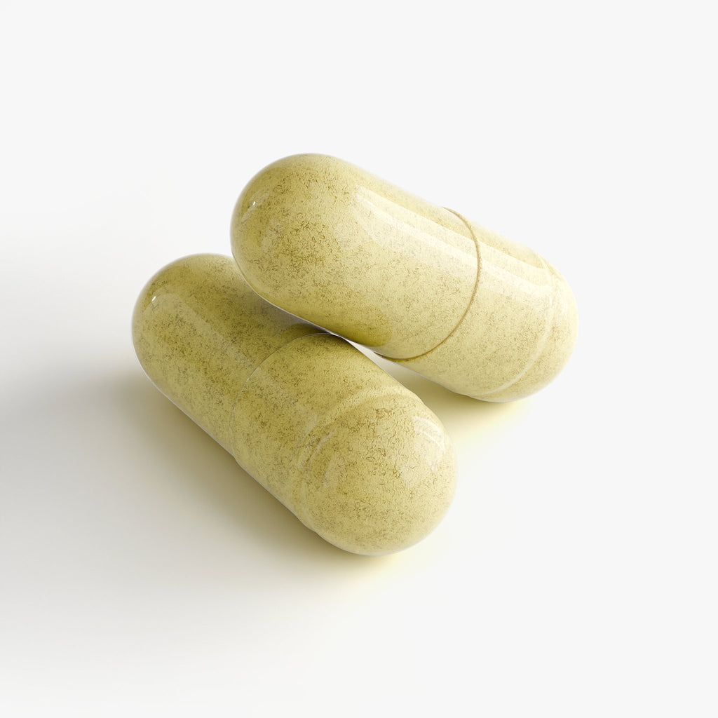 Two green capsules on a white background