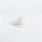 White scoop with powder on a white background