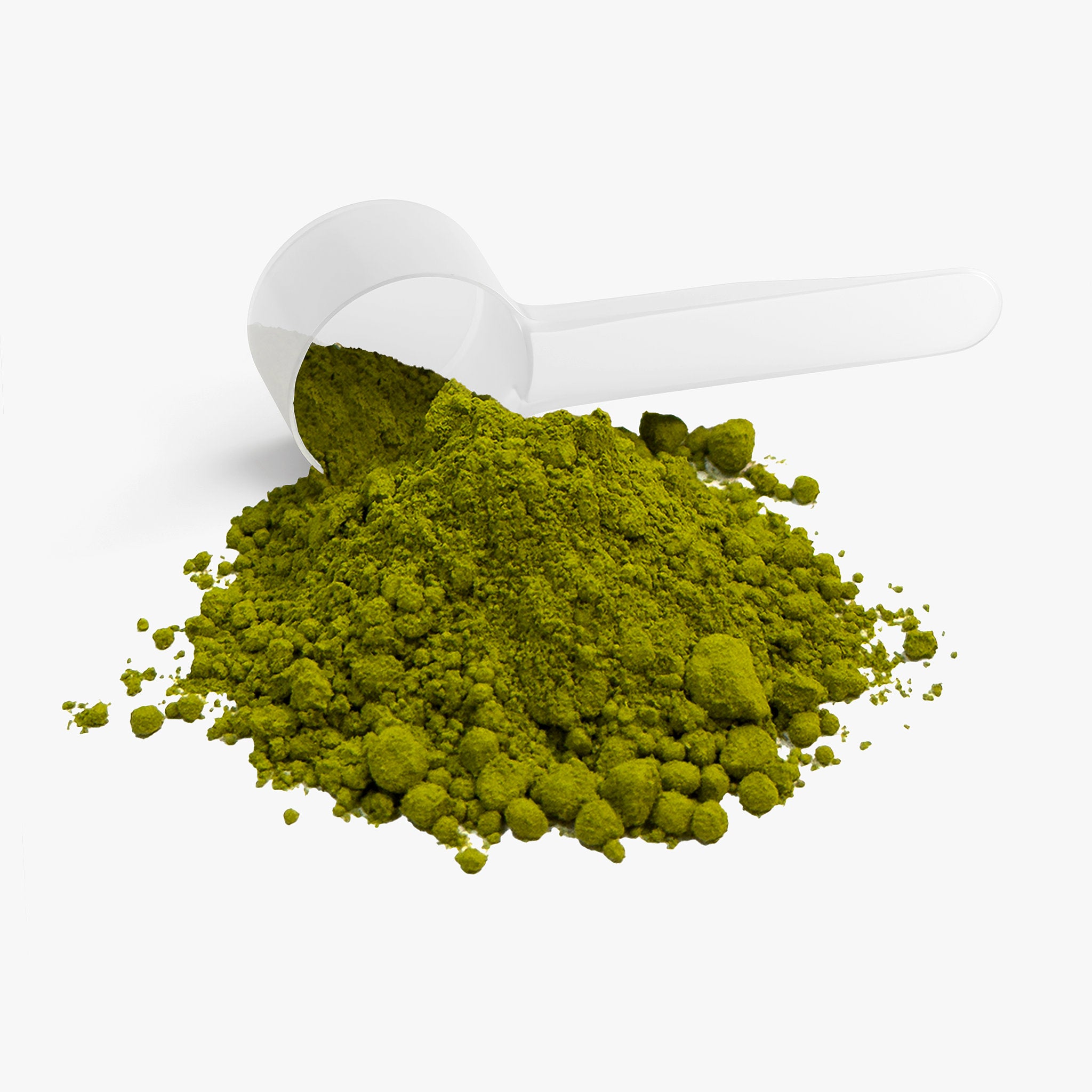 Green powder spilling out of a white scoop on a white background