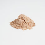 Two mounds of beige powder on a light gray background