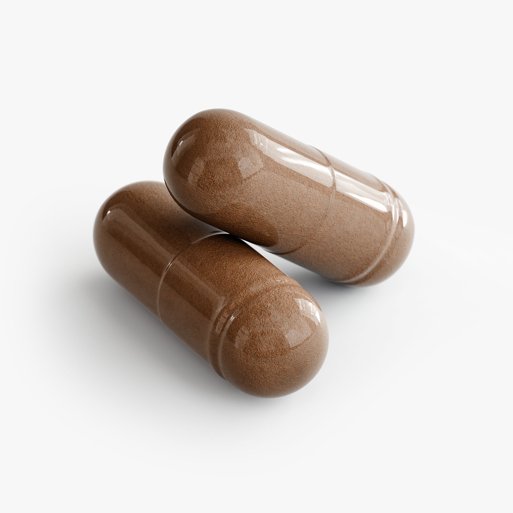 Two brown capsules on a white background