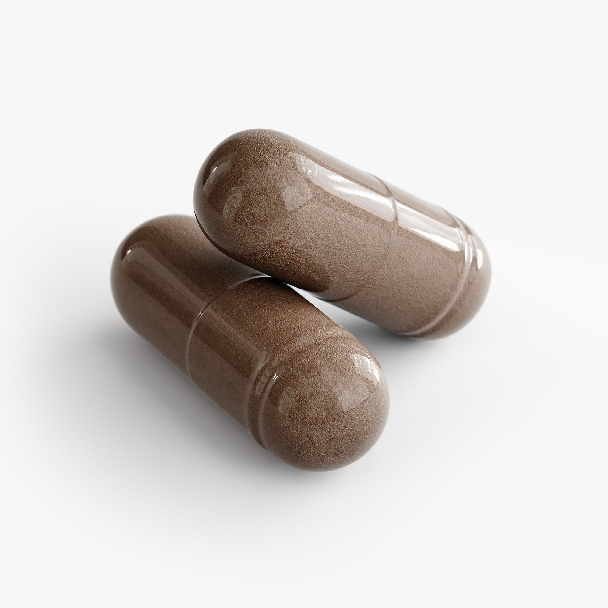 Two brown capsules on a white background